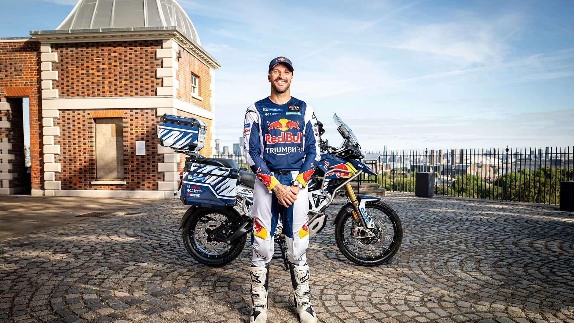Sam Sunderland lângă Triumph Tiger 1200 Rally Explorer pregătită pentru tentativa de record în jurul lumii