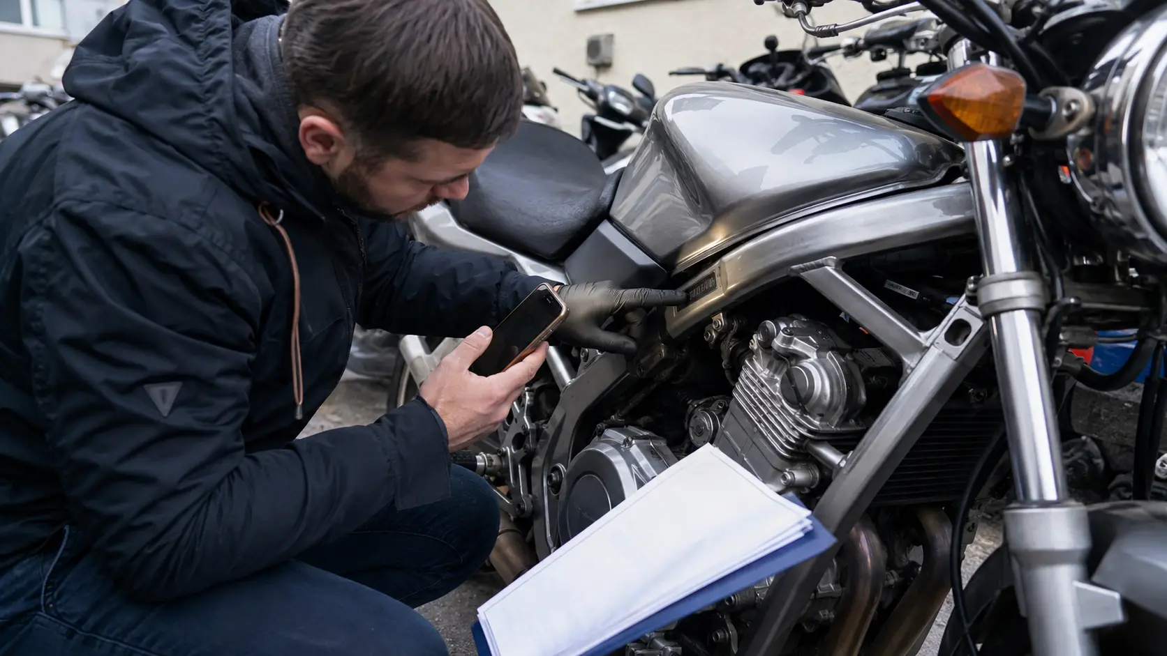 Cumpărător verificând zona seriei VIN la o motocicletă second-hand