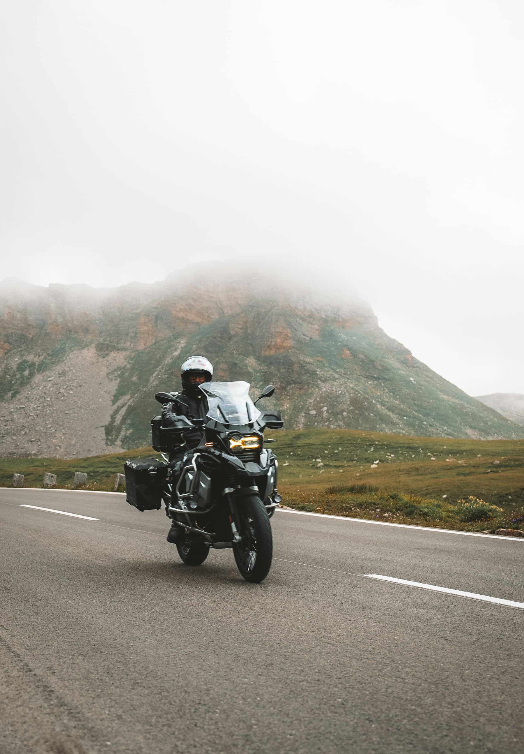 Motociclist echipat complet pe un drum de munte